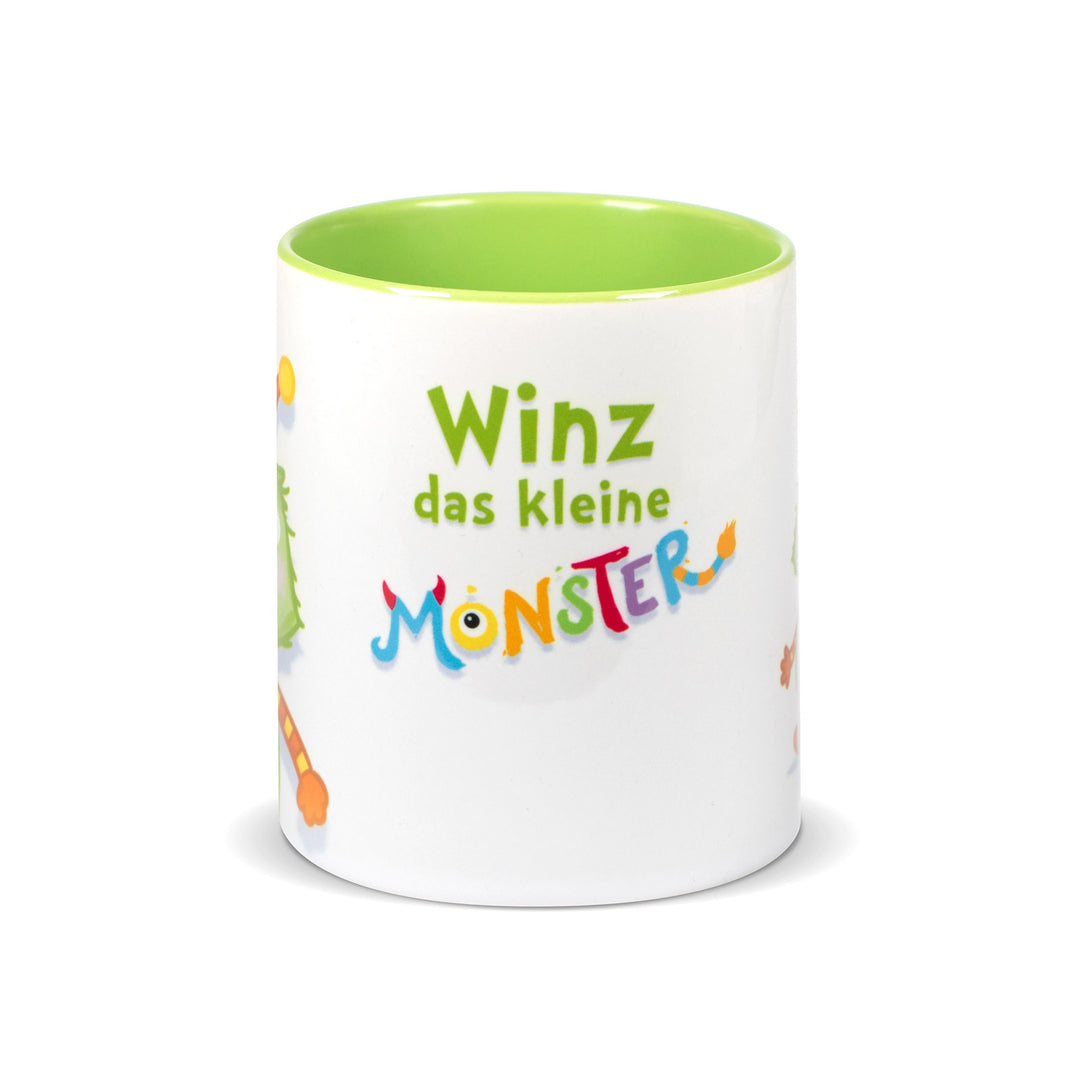 Weiße Keramiktasse mit hellgrünem Innenrand und der Aufschrift „Winz das kleine Monster“ in bunter, verspielter Schrift.
